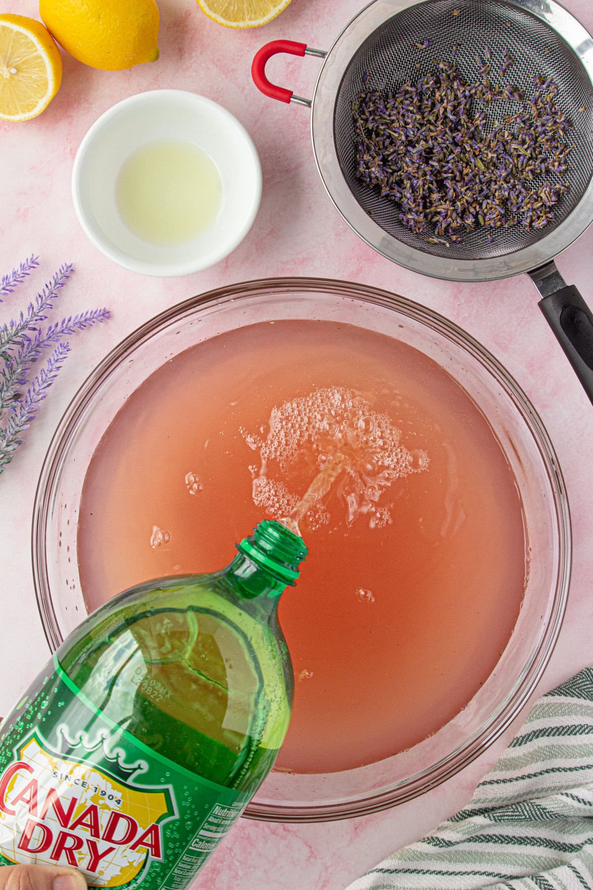 Ginger ale being poured into the punch bowl.