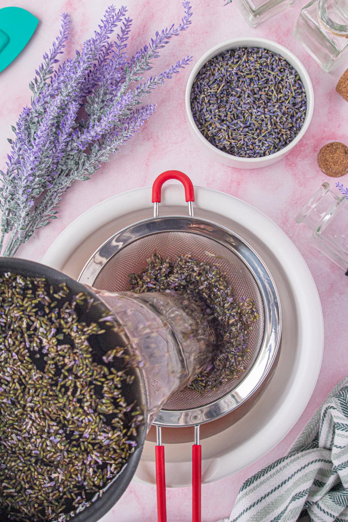 Straining the lavender out of the simple syrup.