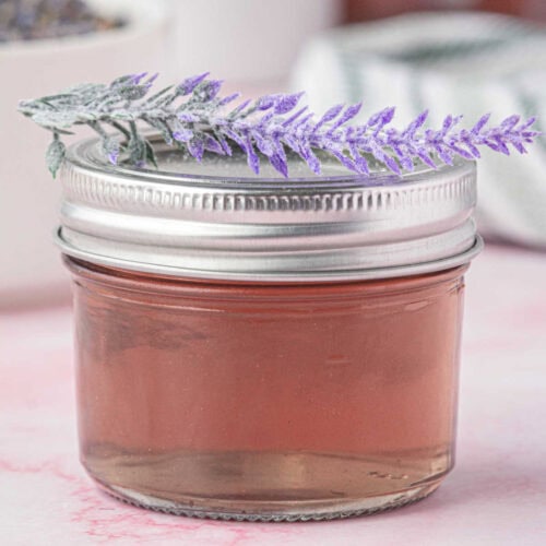 Closeup of lavender syrup in a jar.