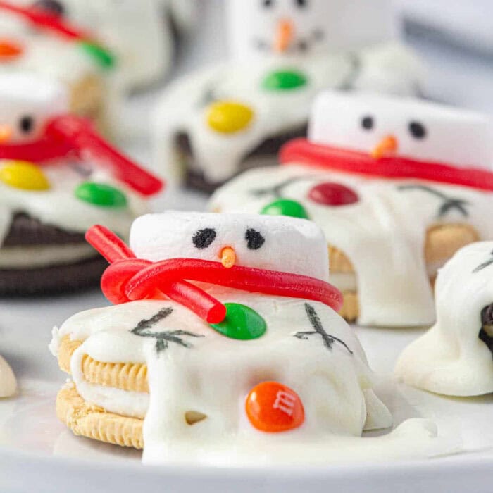 Cookies decorated with marshmallows made to look like a snowman that's. melting.