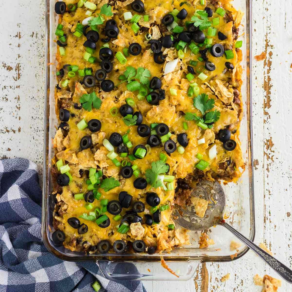 Overhead view of the finished casserole garnished with olives and green onions.