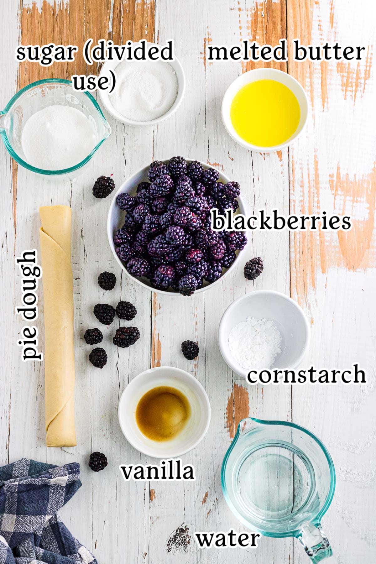 Labeled ingredients for blackberry cobbler with pie crust.