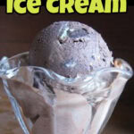 A scoop of chocolate ice cream in a glass ice cream dish with a title text overlay for Pinterest.