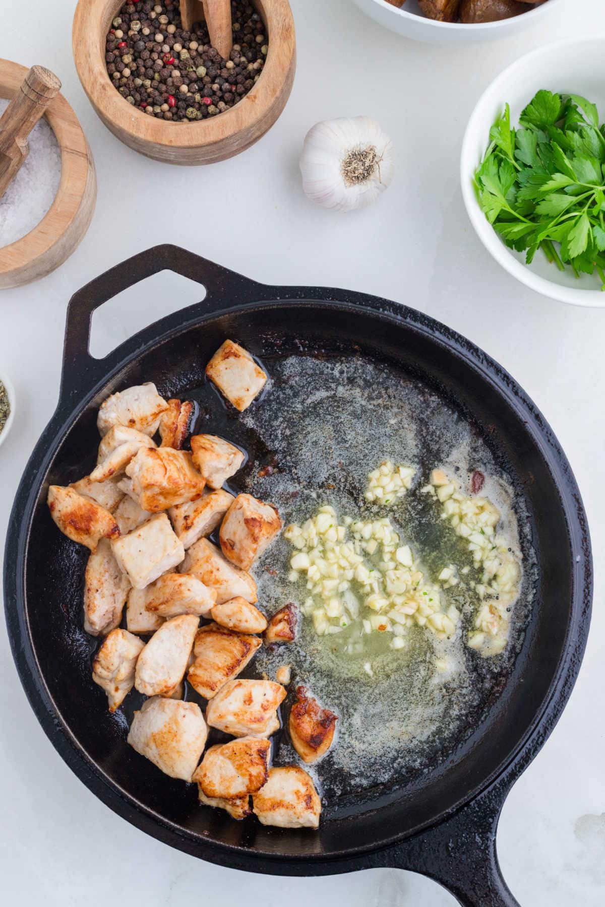 Cooking the garlic in butter in the skillet.