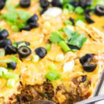 Closeup of ground beef nacho casserole with title text overlay for Pinterest.