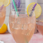 A stemmed glass of lavender punch with title text overlay for Pinterest.