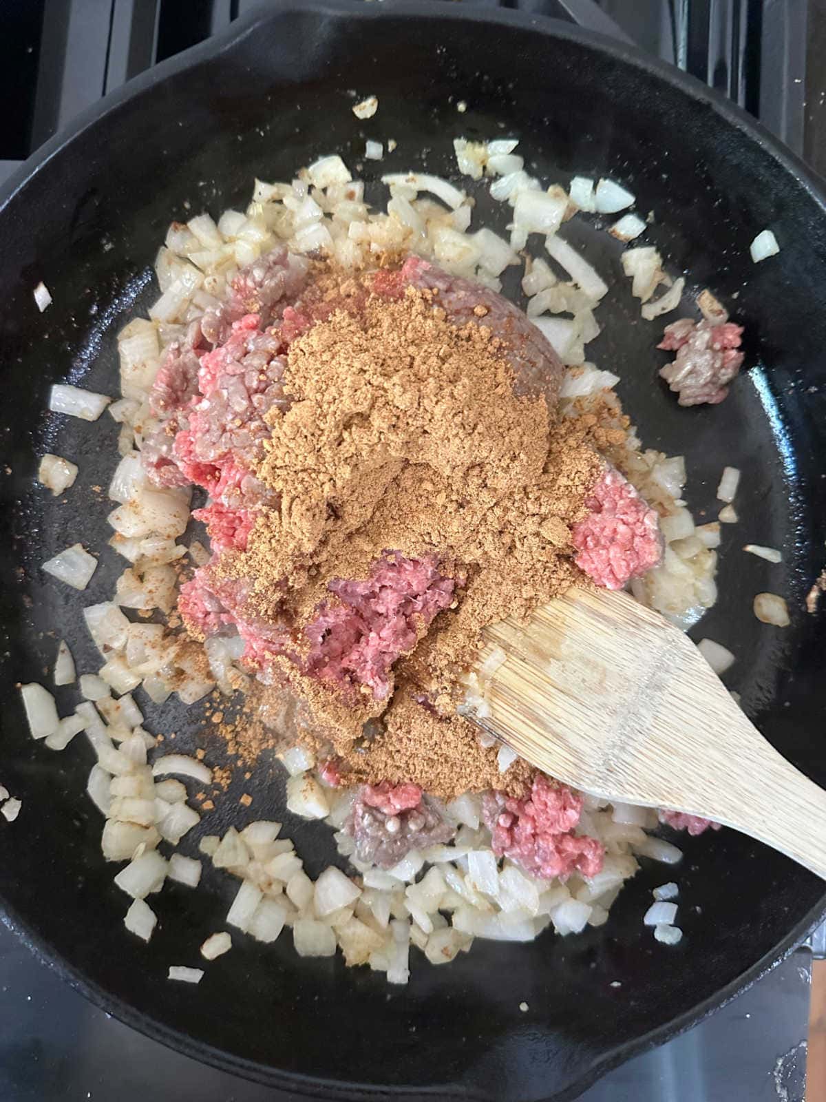 Browning the beef with taco seasoning.