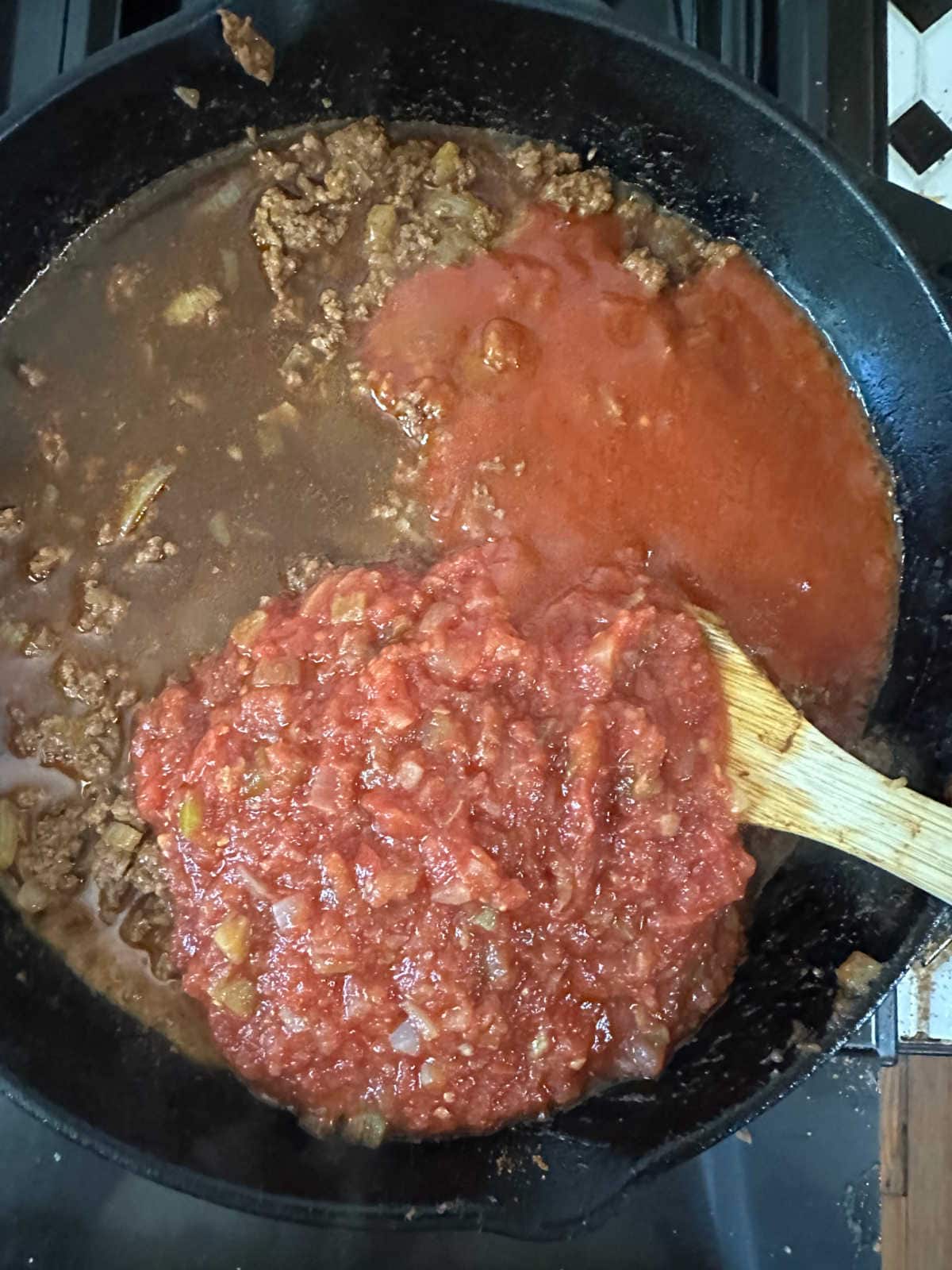 Combining the sauce with the meat mixture.