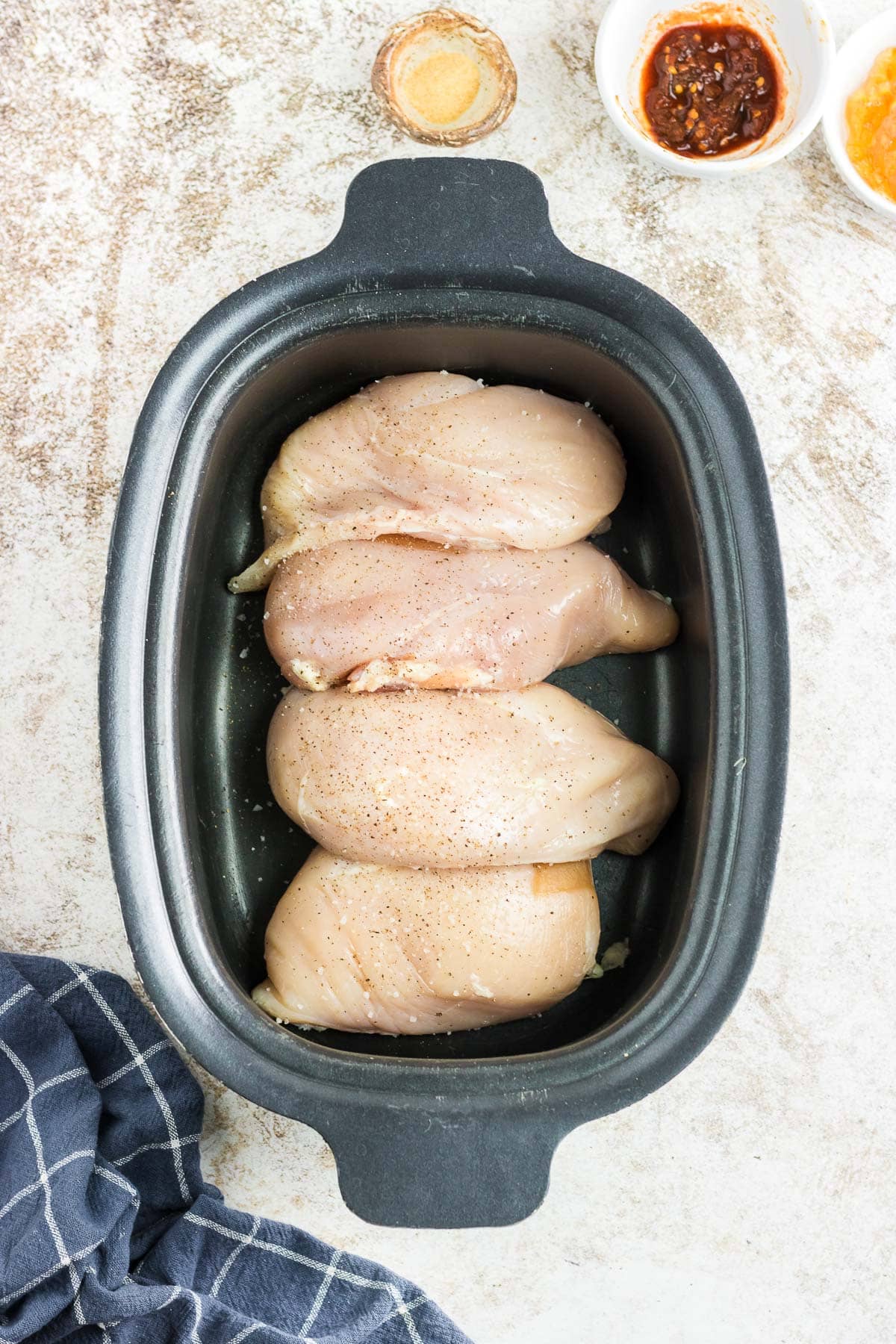 Boneless chicken breasts in the slow cooker.