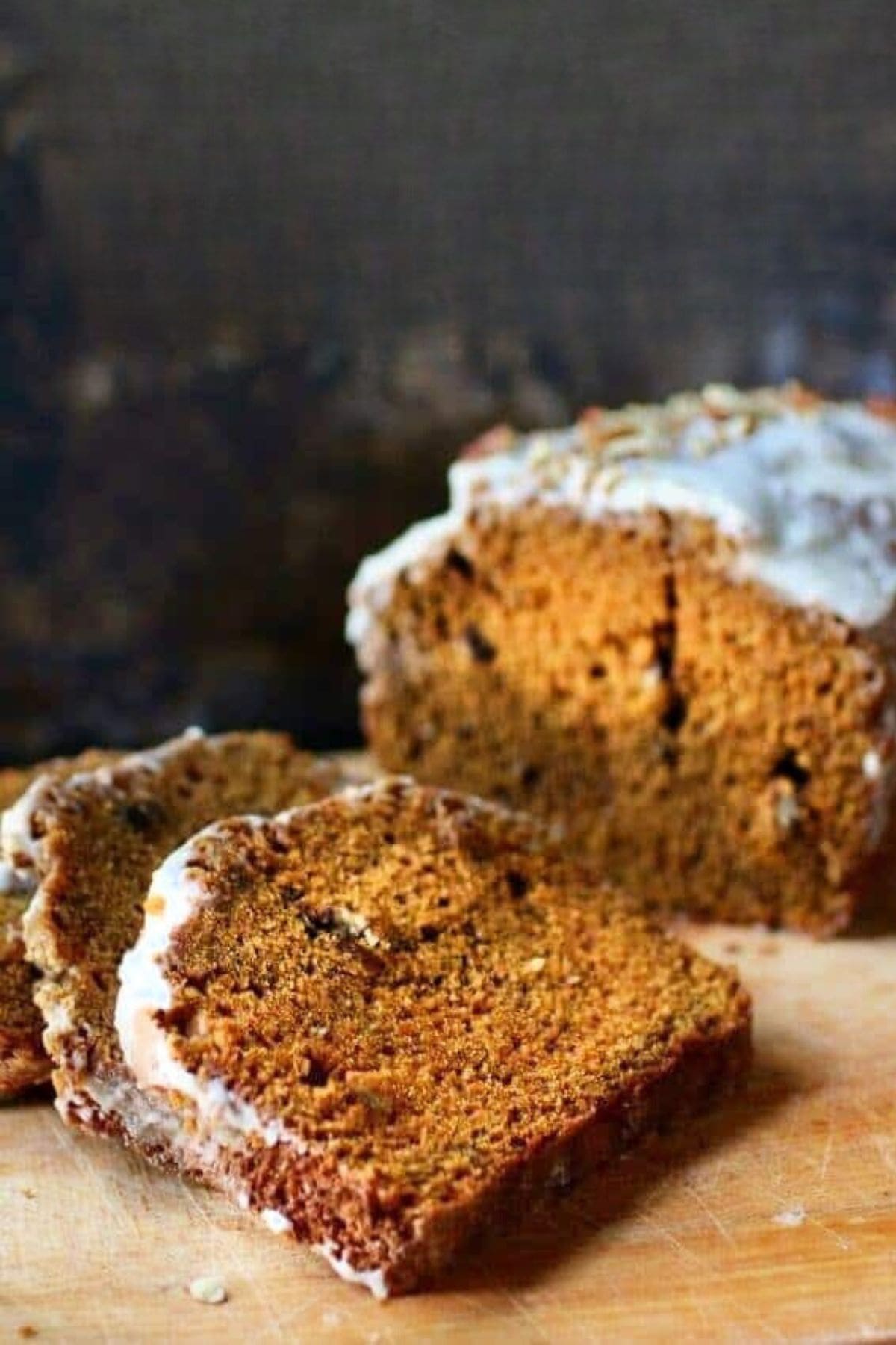 Close up of a loaf of pumpkin bread that's been sliced.