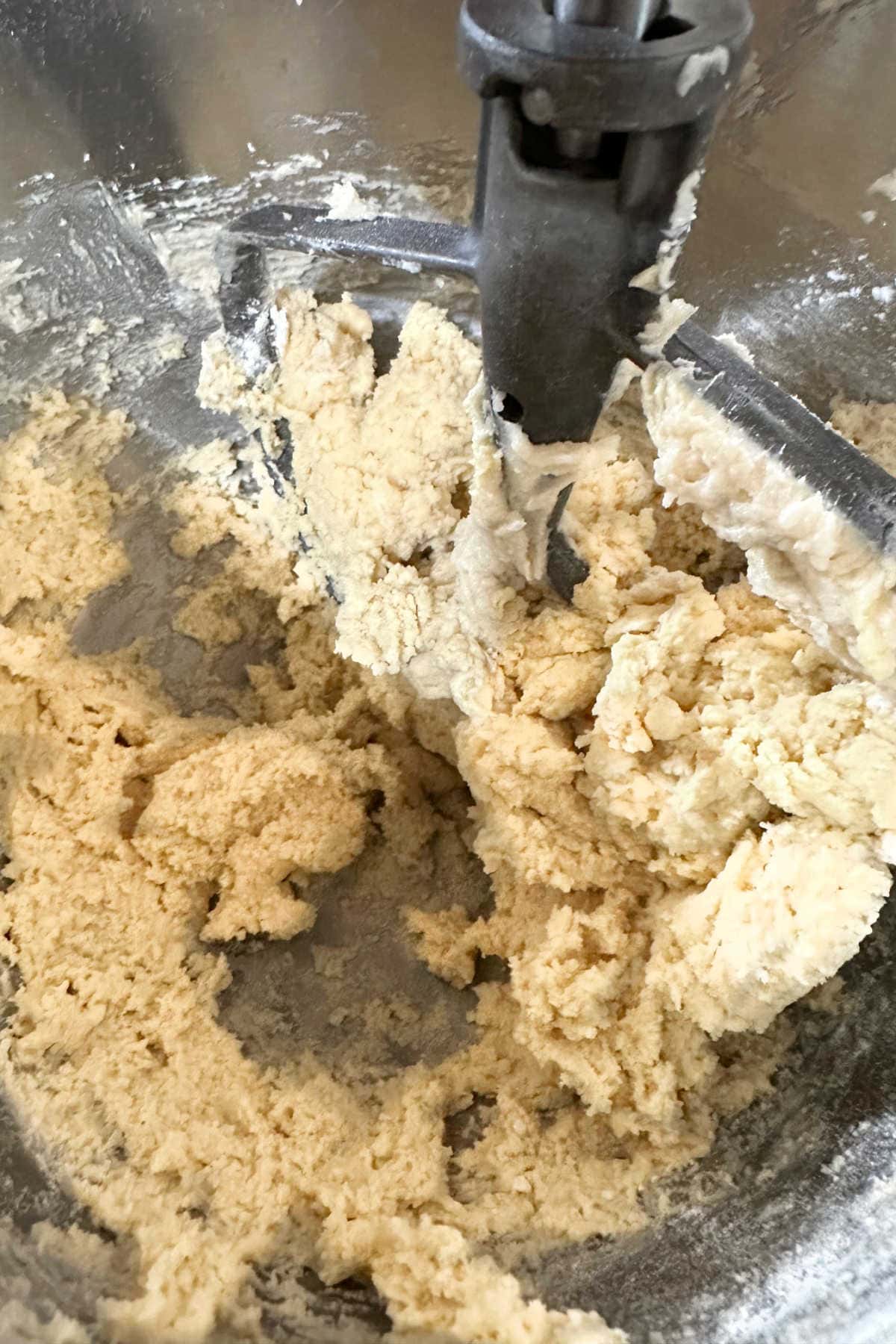 Mixing the wet and dry ingredients into cookie dough.