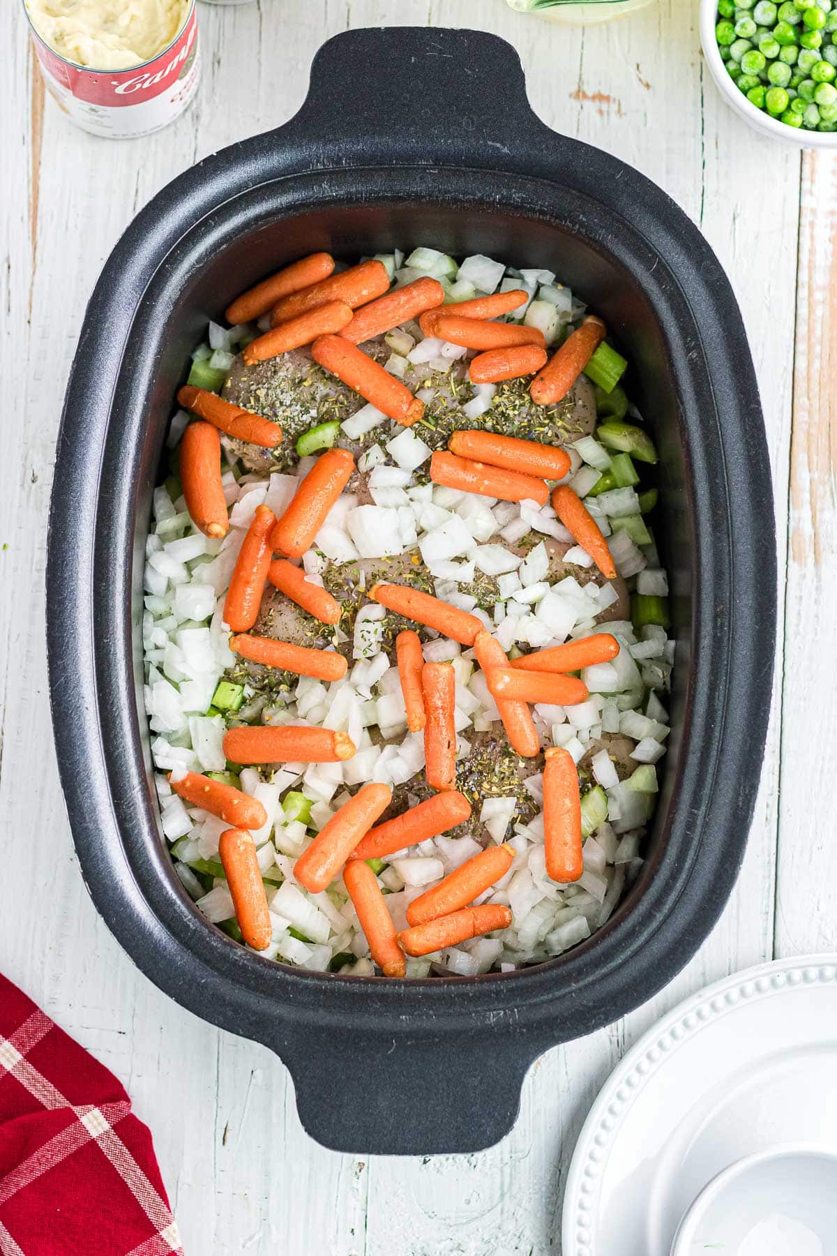 Adding carrots, onion, and celery to the chicken.