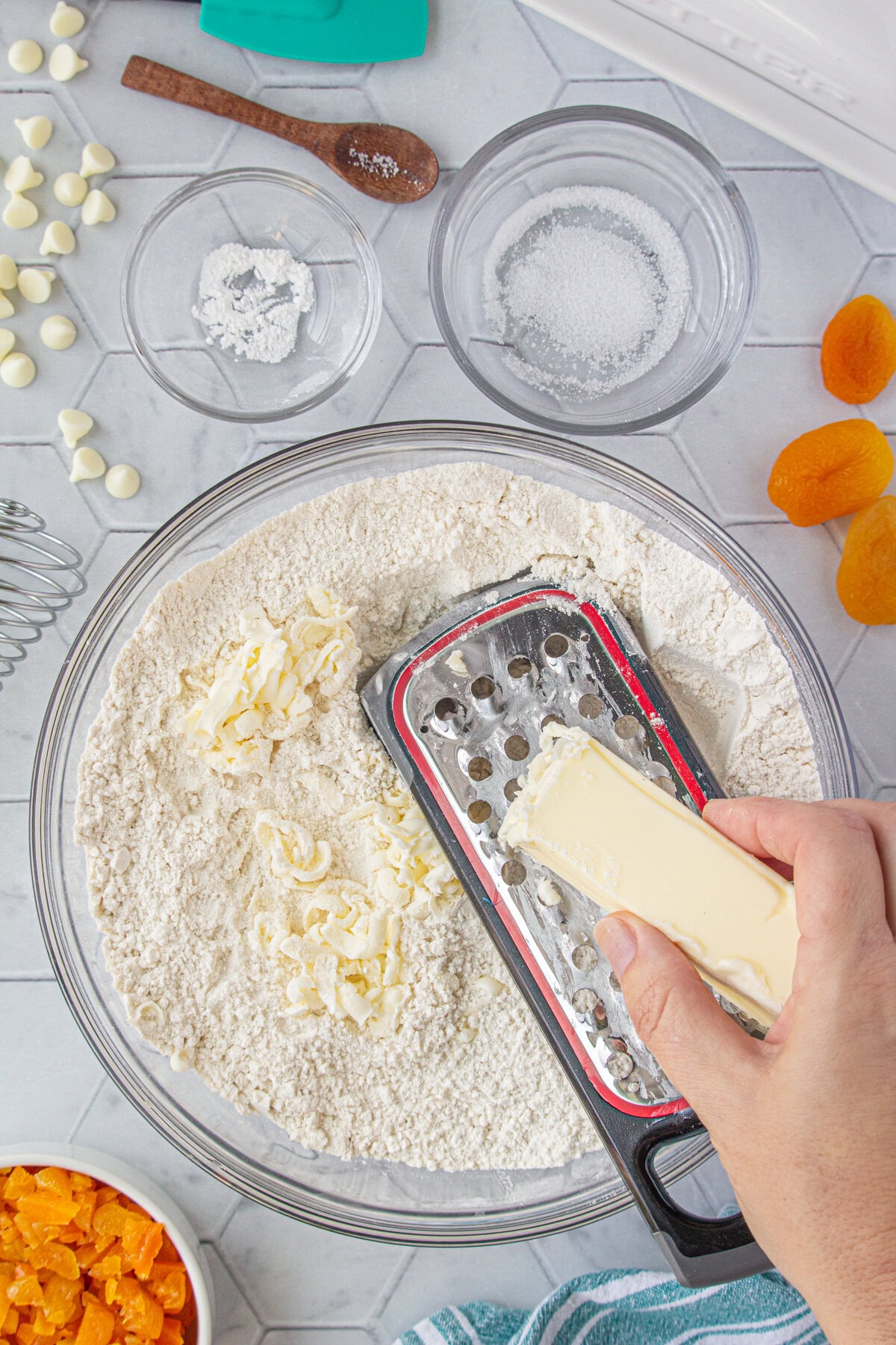 Grating the cold butter into the dry ingredients.