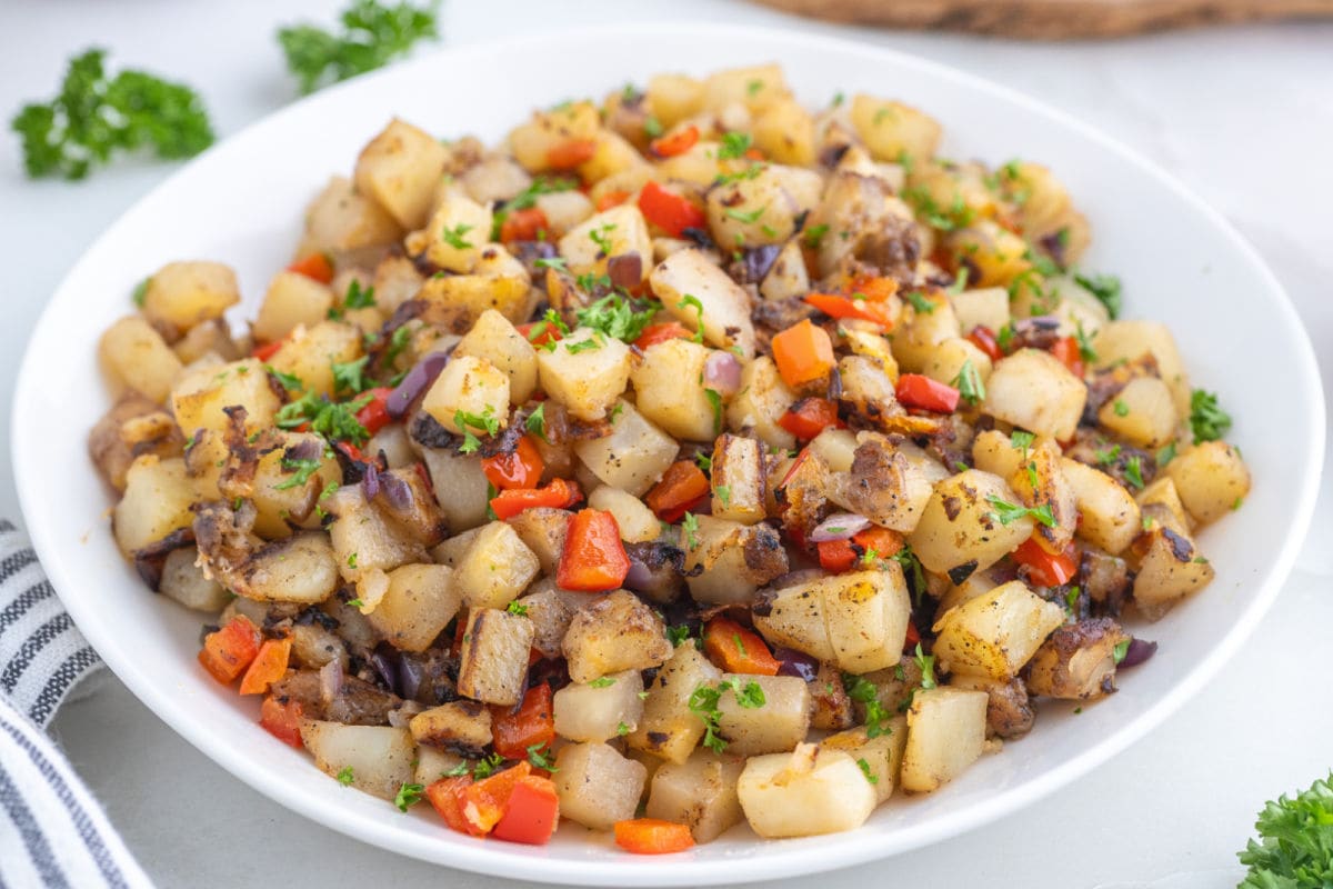 Country potatoes served in a white bowl.