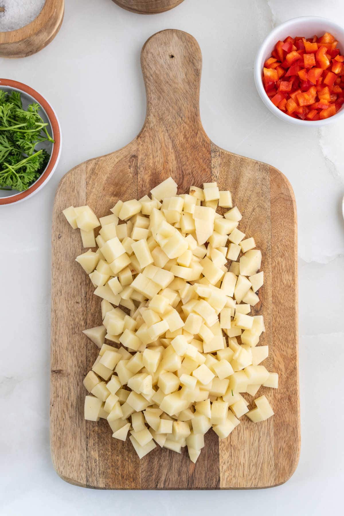 Diced potatoes on a cutting board.