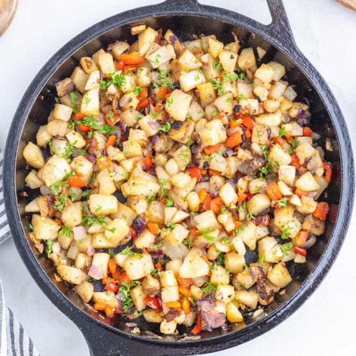 Cooked potatoes in a cast iron skillet.