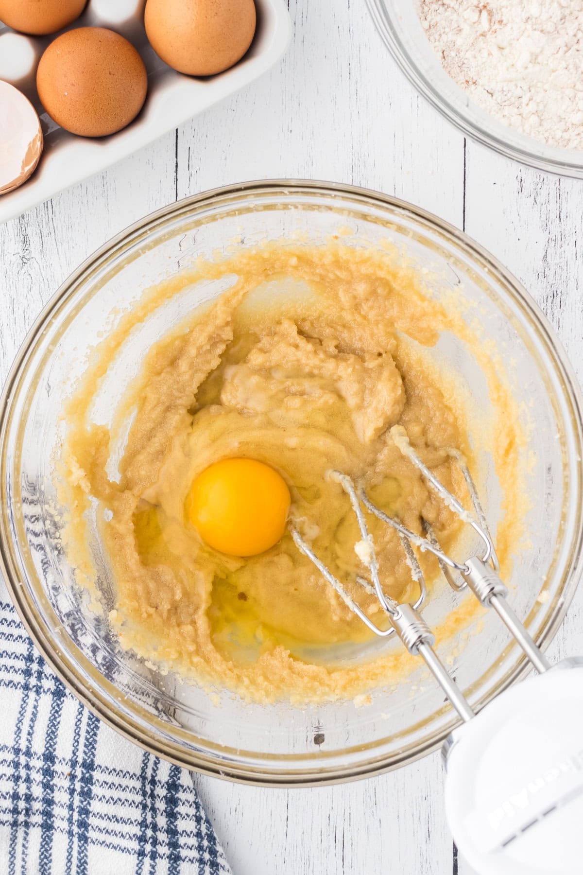 Eggs being mixed into the butter and sugar mixture.