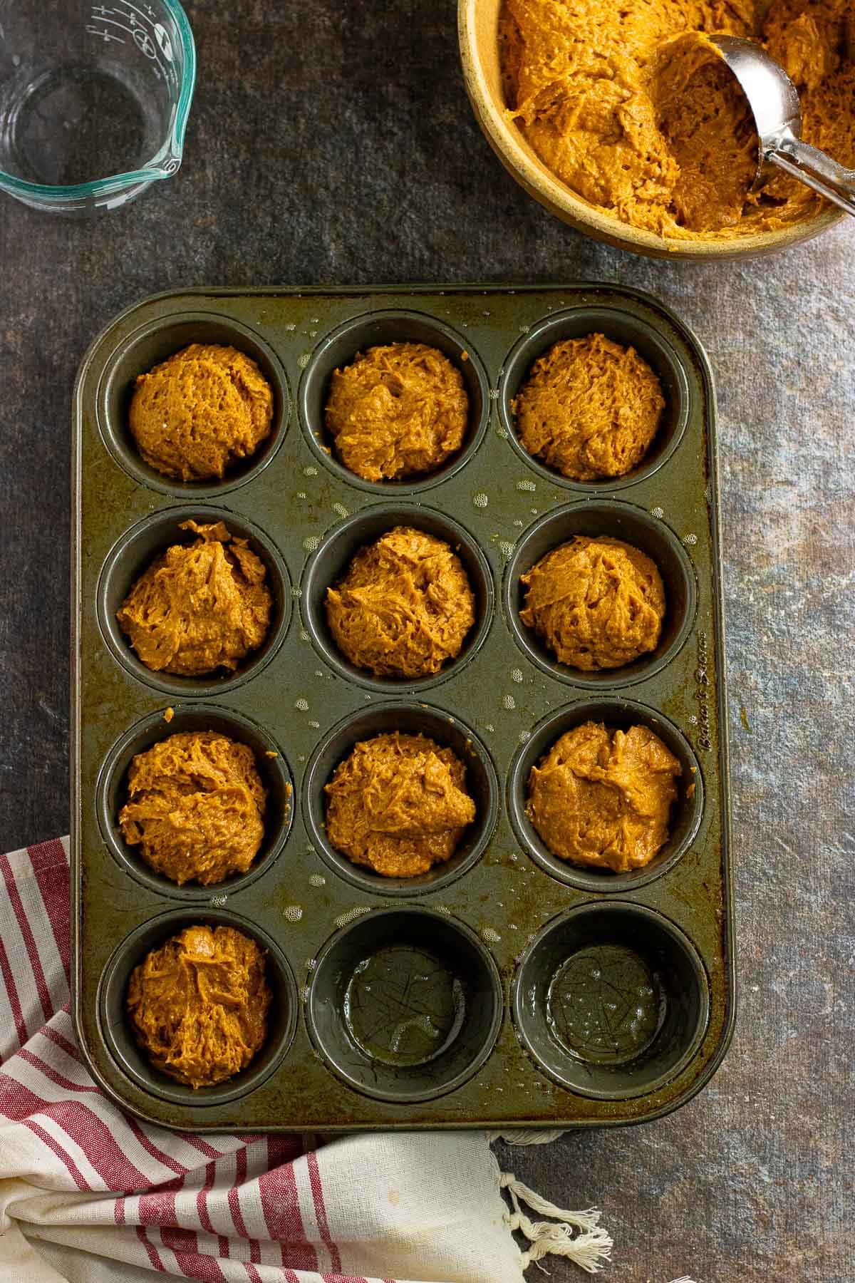 The muffin batter portioned into a muffin tin.