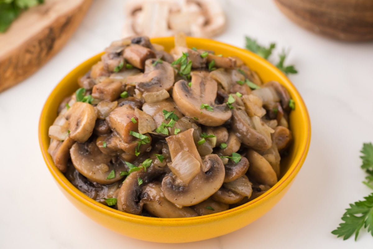 Sauteed mushrooms and onions in a bowl on the table.