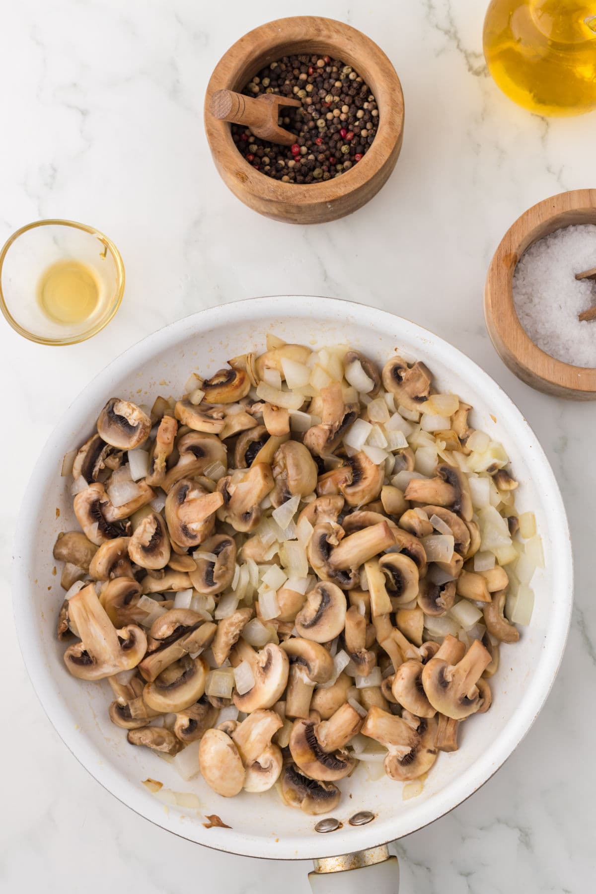 Finished mushrooms and onions in a pan.