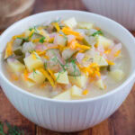 Dill pickle soup in a white bowl.