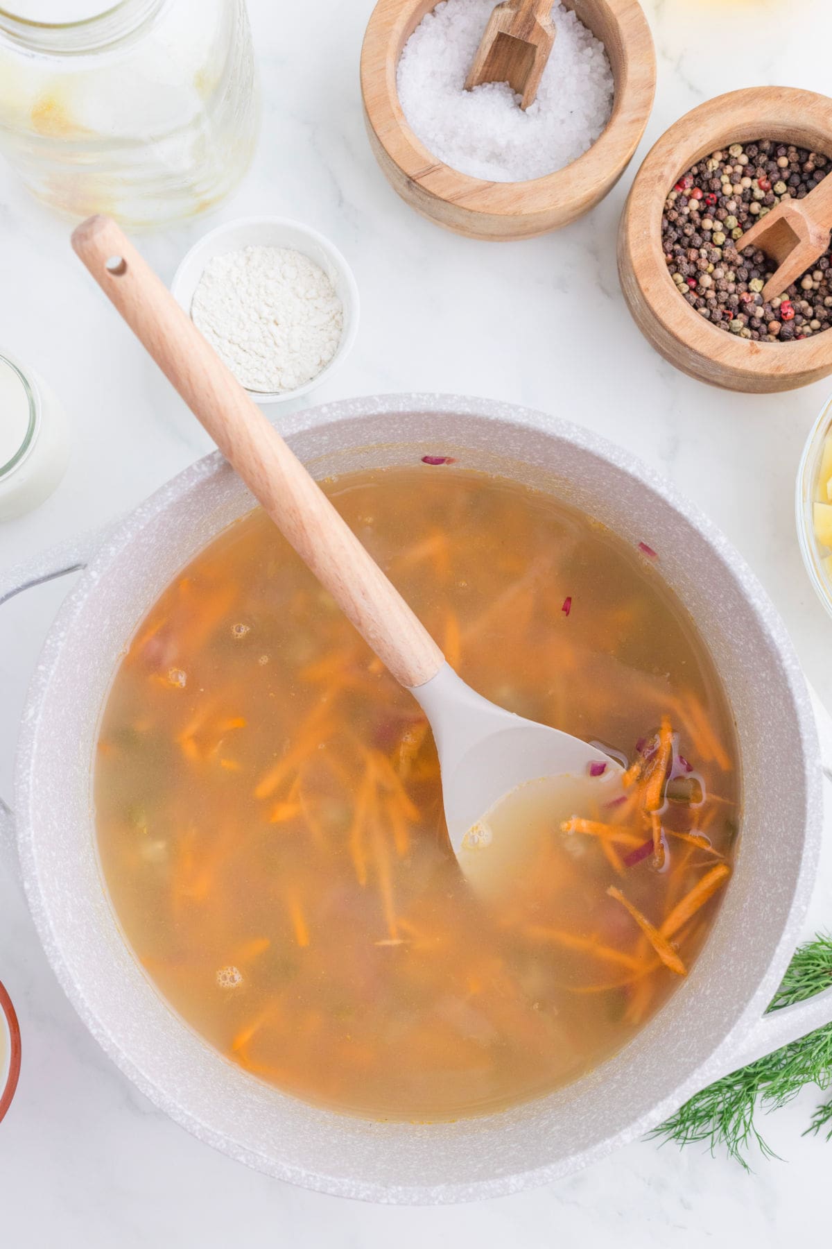 Chicken broth added to the pan.