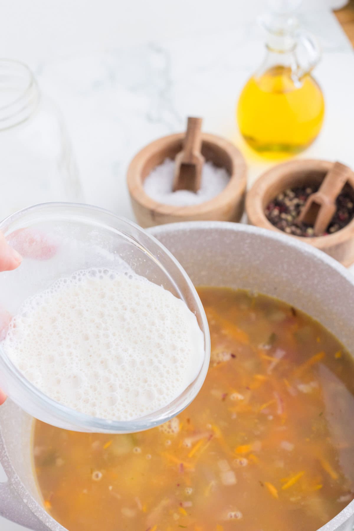 Soup being thickened with flour mixture.