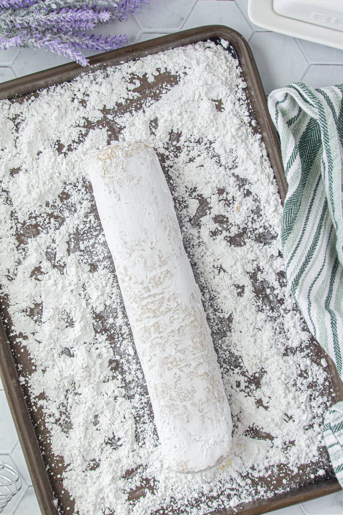 The dough log rolled in powdered sugar.