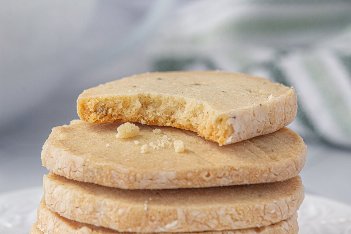 Buttery lavender shortbread cookies with a bit taken out.