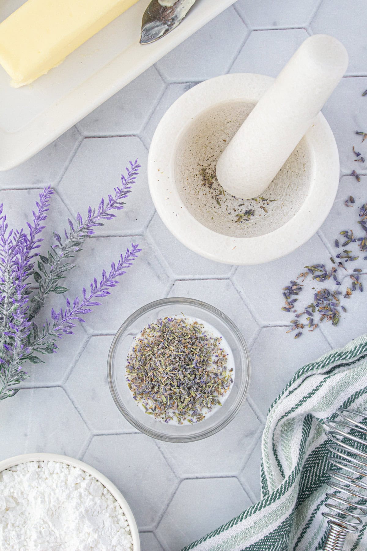 Grinding the lavender and soaking it in milk.