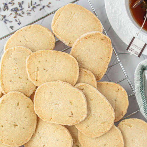 Overhead view of a pile of lavender shortbread cookies.