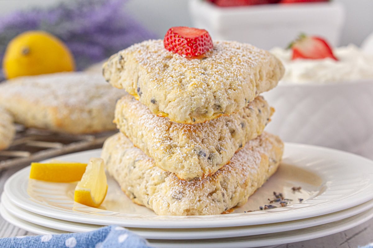 Lavender scones stacked on each other on a serving plate.