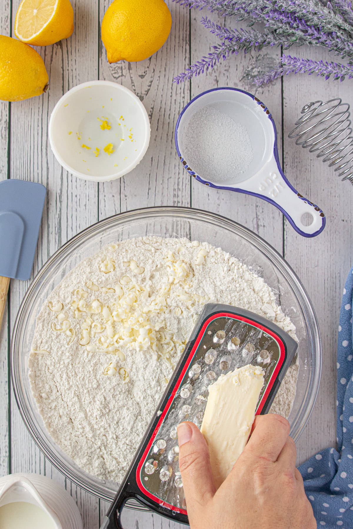 Grating the frozen butter into the dry ingredients.