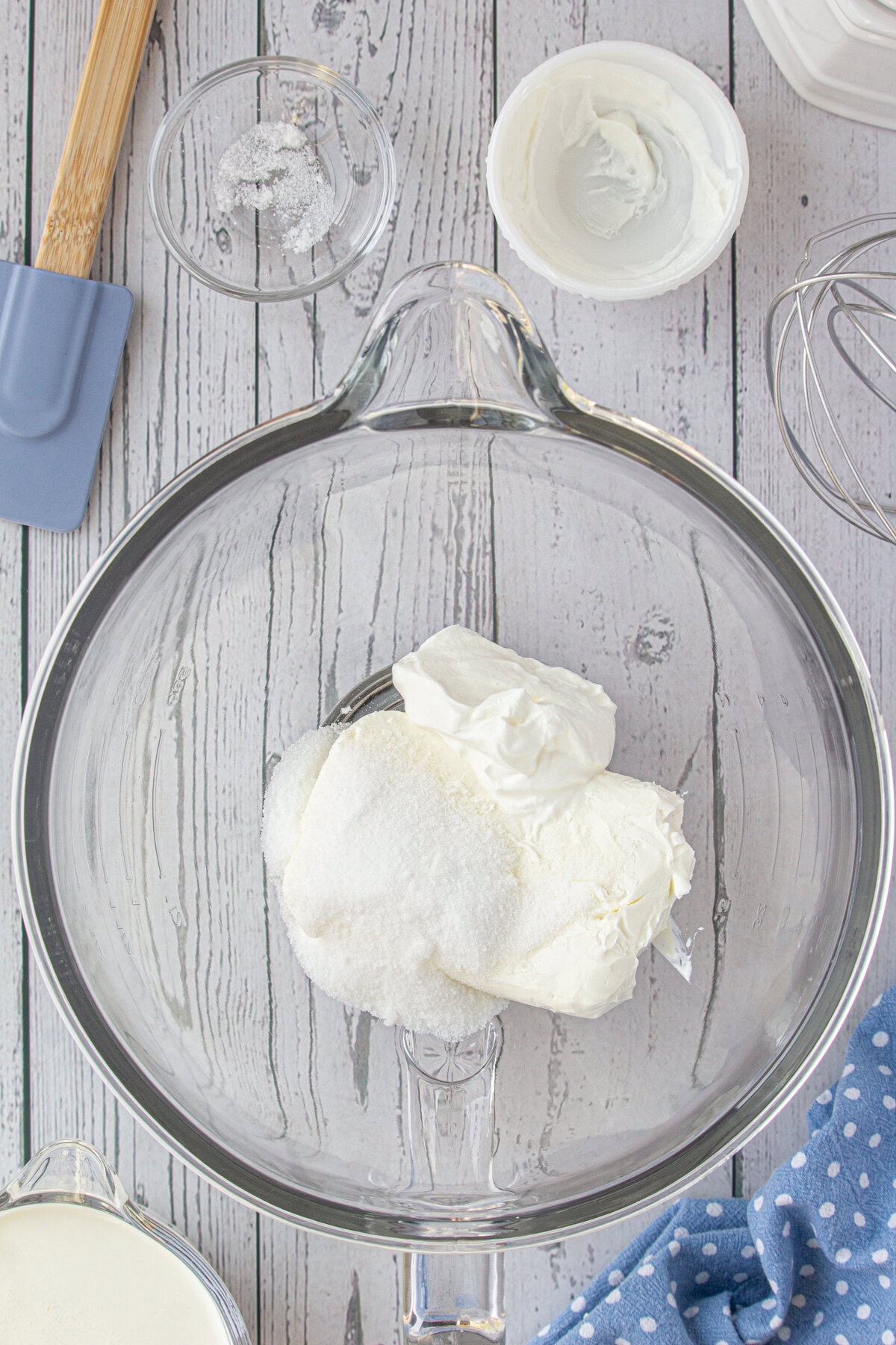 Cream cheese, sugar, and sour cream in a bowl.