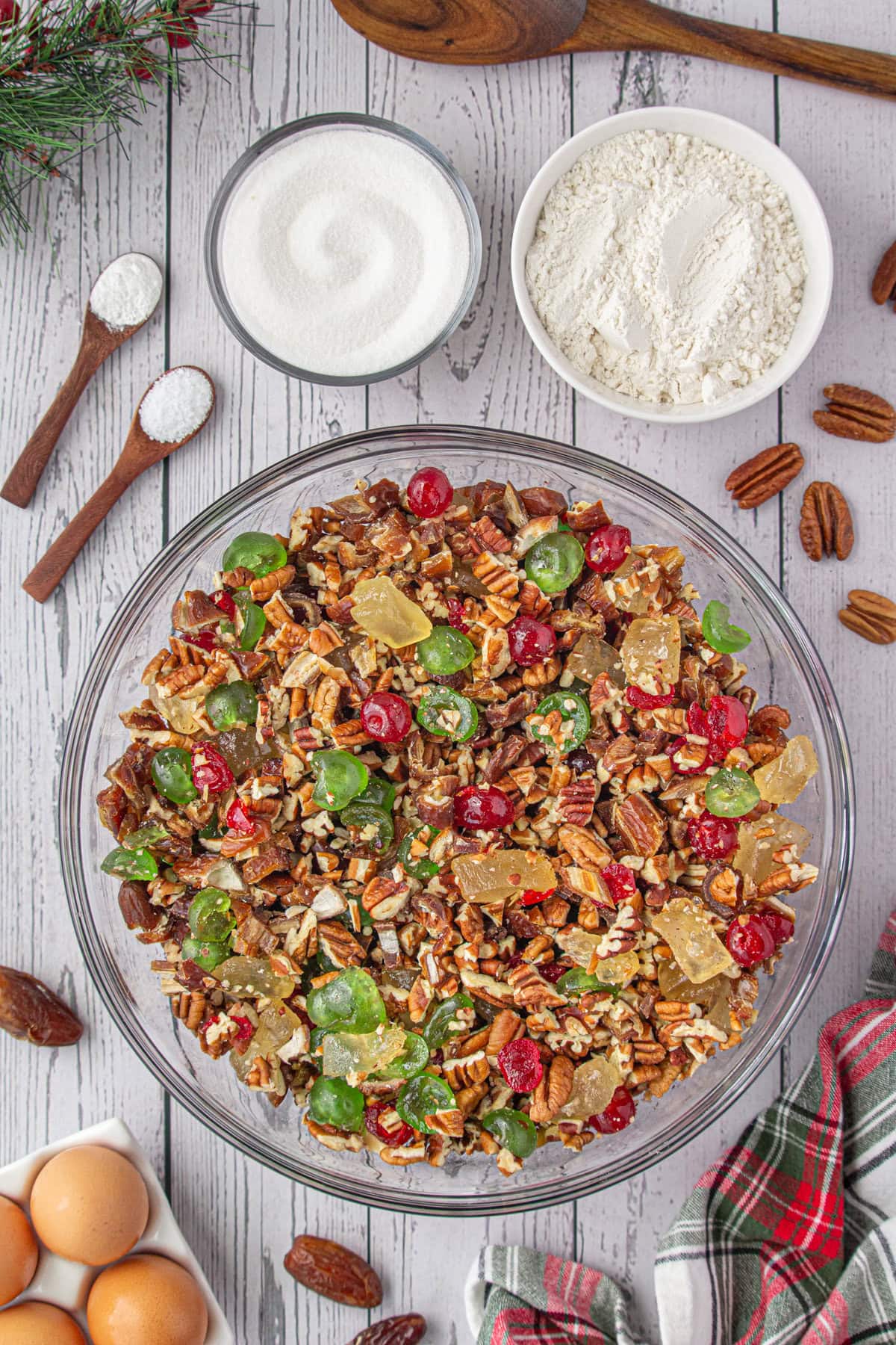 Candied fruit, dates, and chopped nuts mixed together in a large bowl.