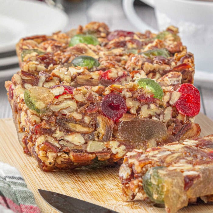 A sliced fruitcake on a cutting board.