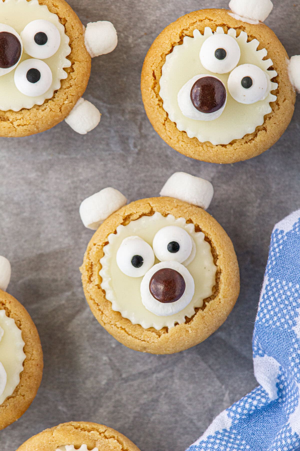 Polar bear cookies made with a Reese's cup face, marshmallow ears, and candy eyes.