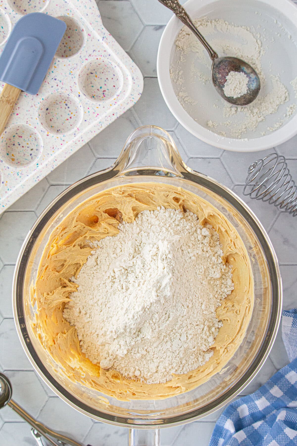 Adding the dry ingredients to the beaten butters.