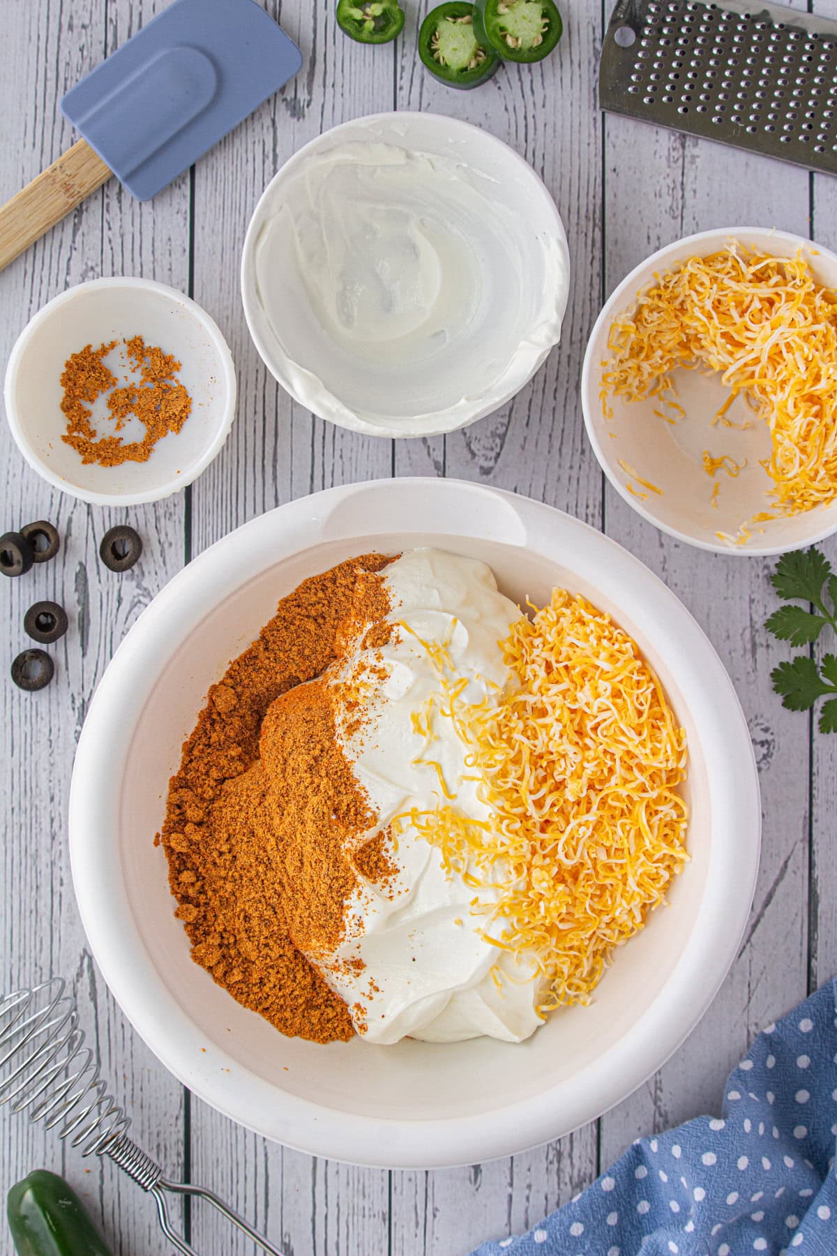 The taco seasoning, sour cream, and cheese added to the cream cheese.