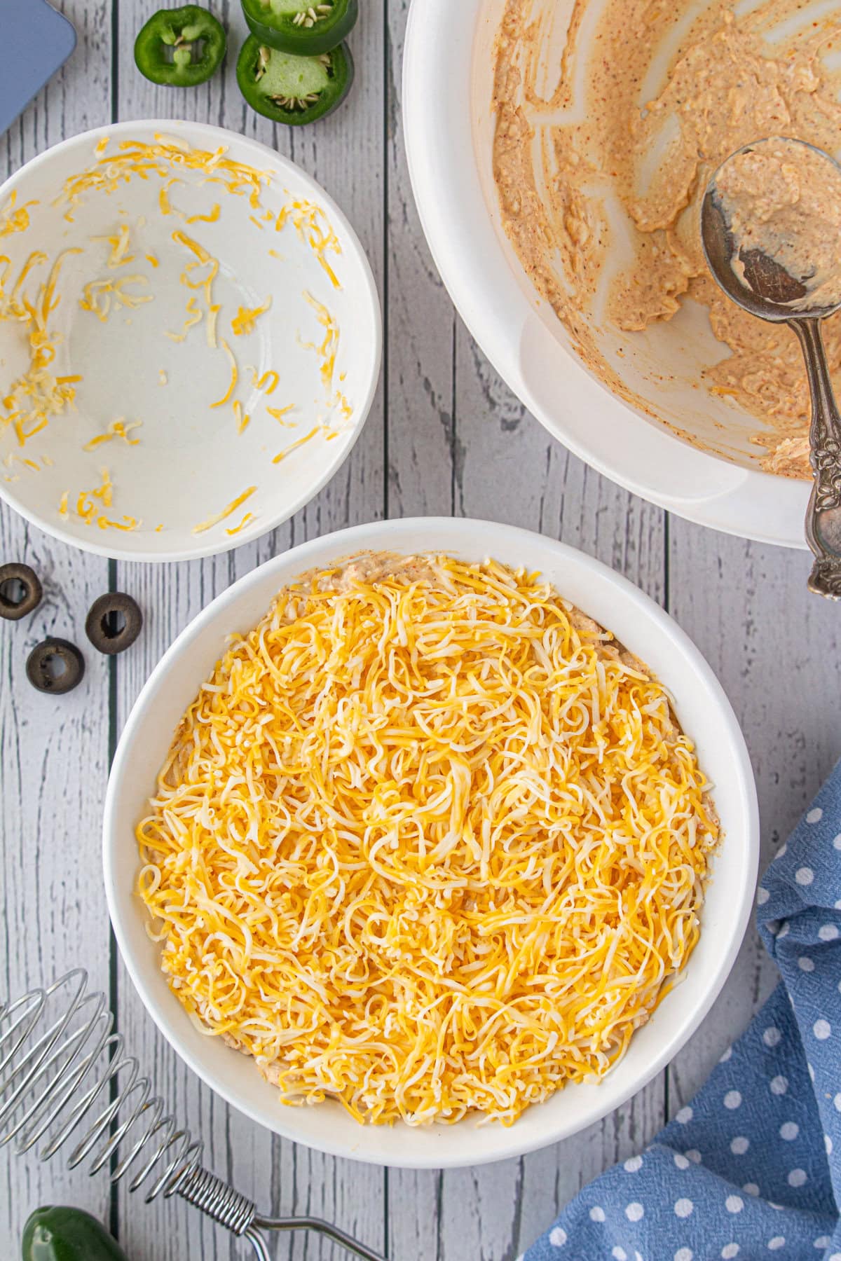 More shredded cheese added to the top of the taco dip.