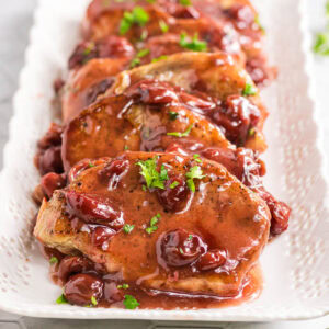 Cherry chipotle pork chops on a platter.