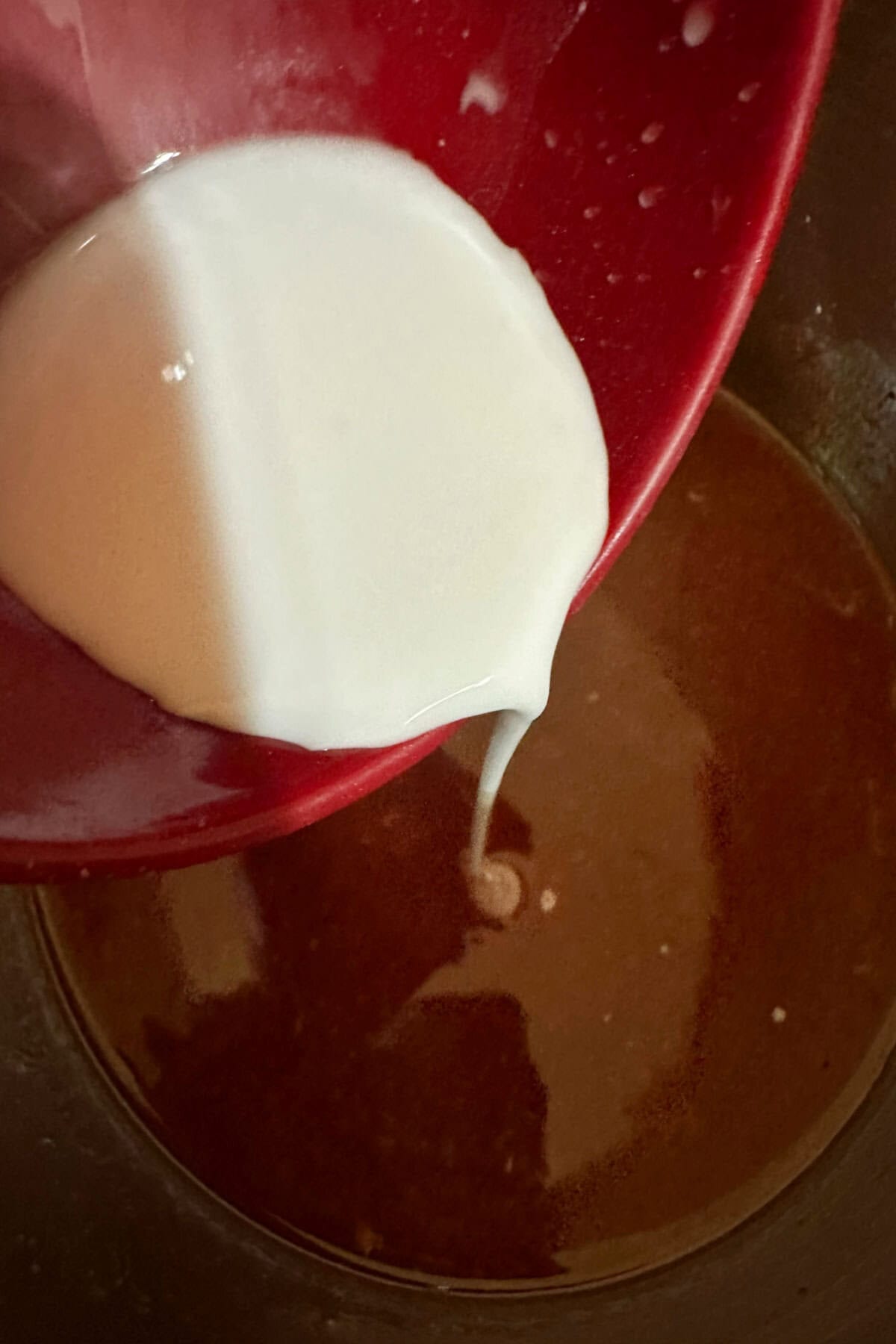 Whisking a cornstarch slurry into the pork juices.