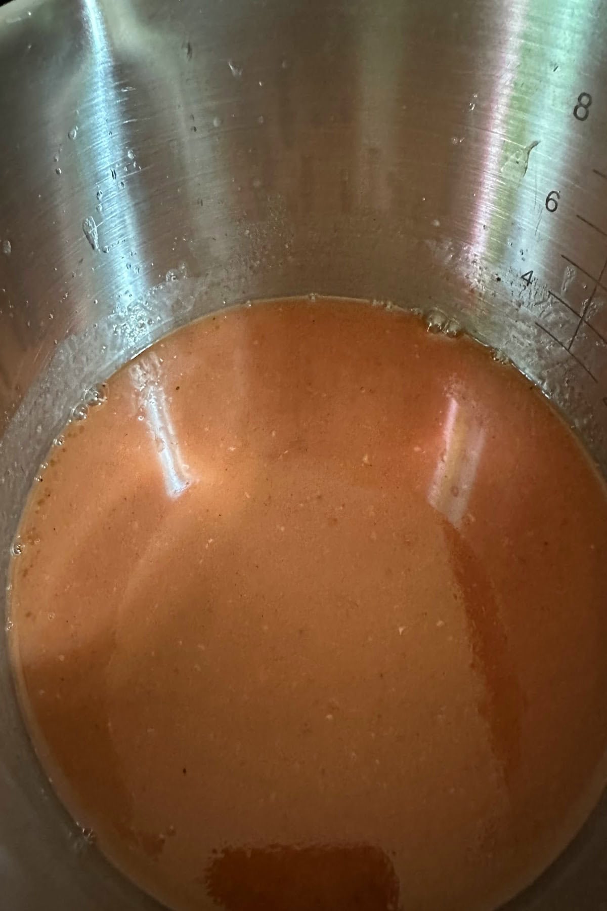 Heating the pork juice in a saucepan.