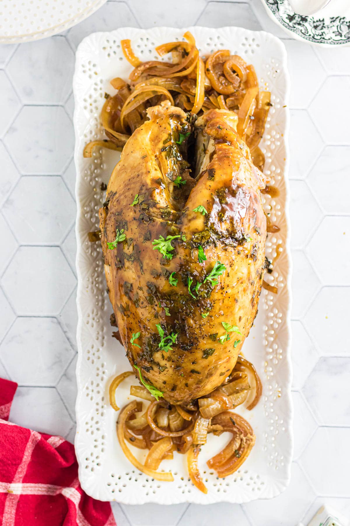 The chipotle citrus turkey breast on a serving platter with onions and cilantro.