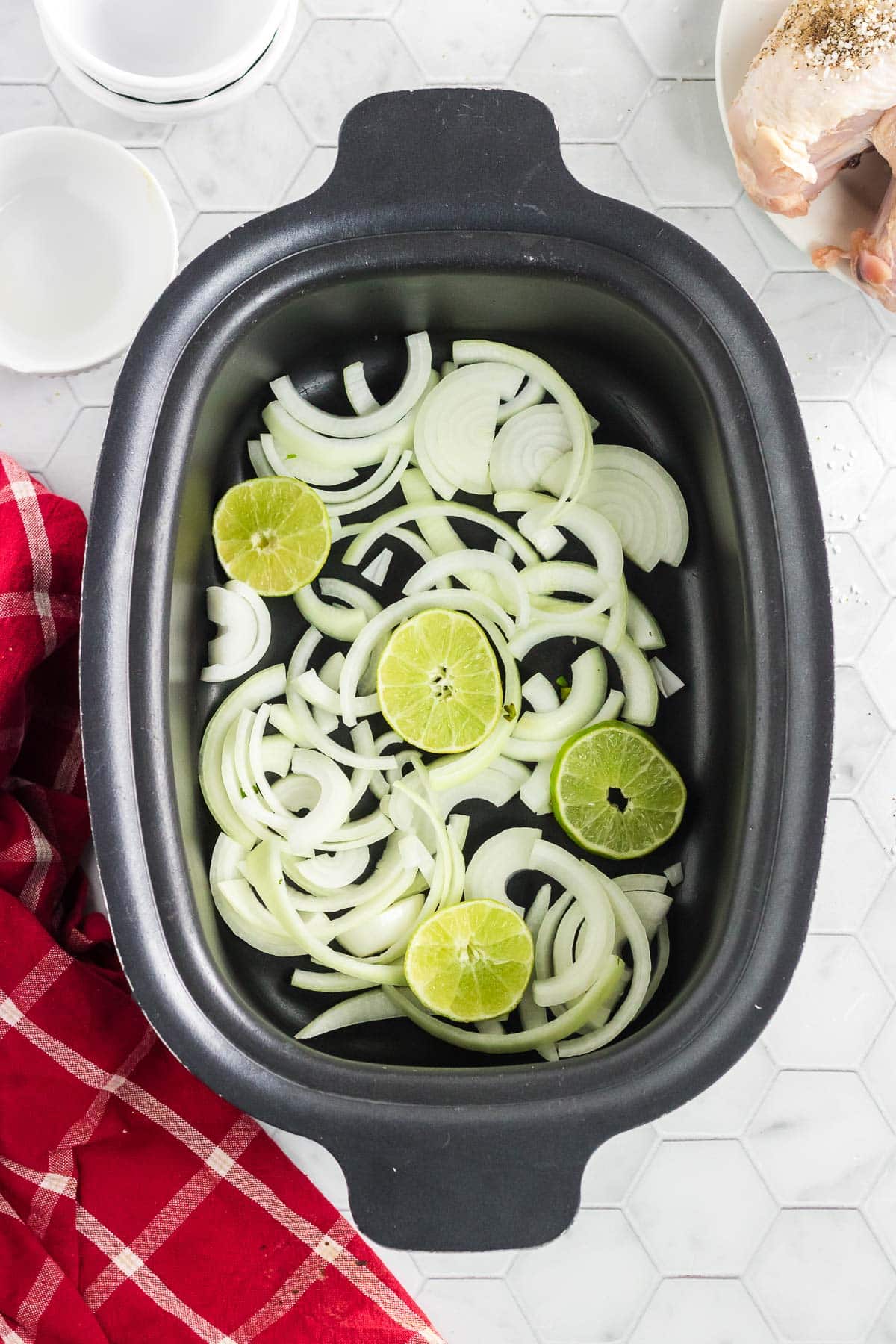 The limes and onions in the slow cooker.