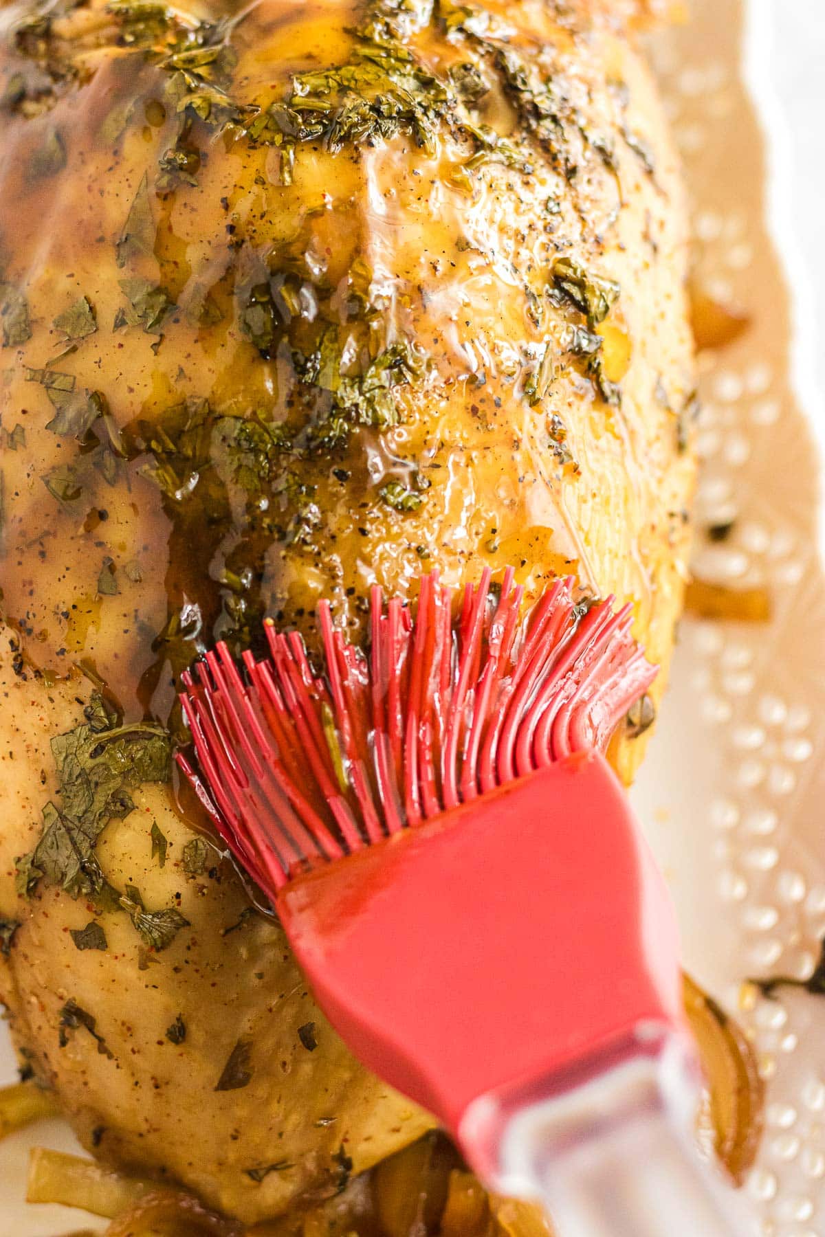 Brushing the turkey breast with the thickened chipotle citrus sauce.