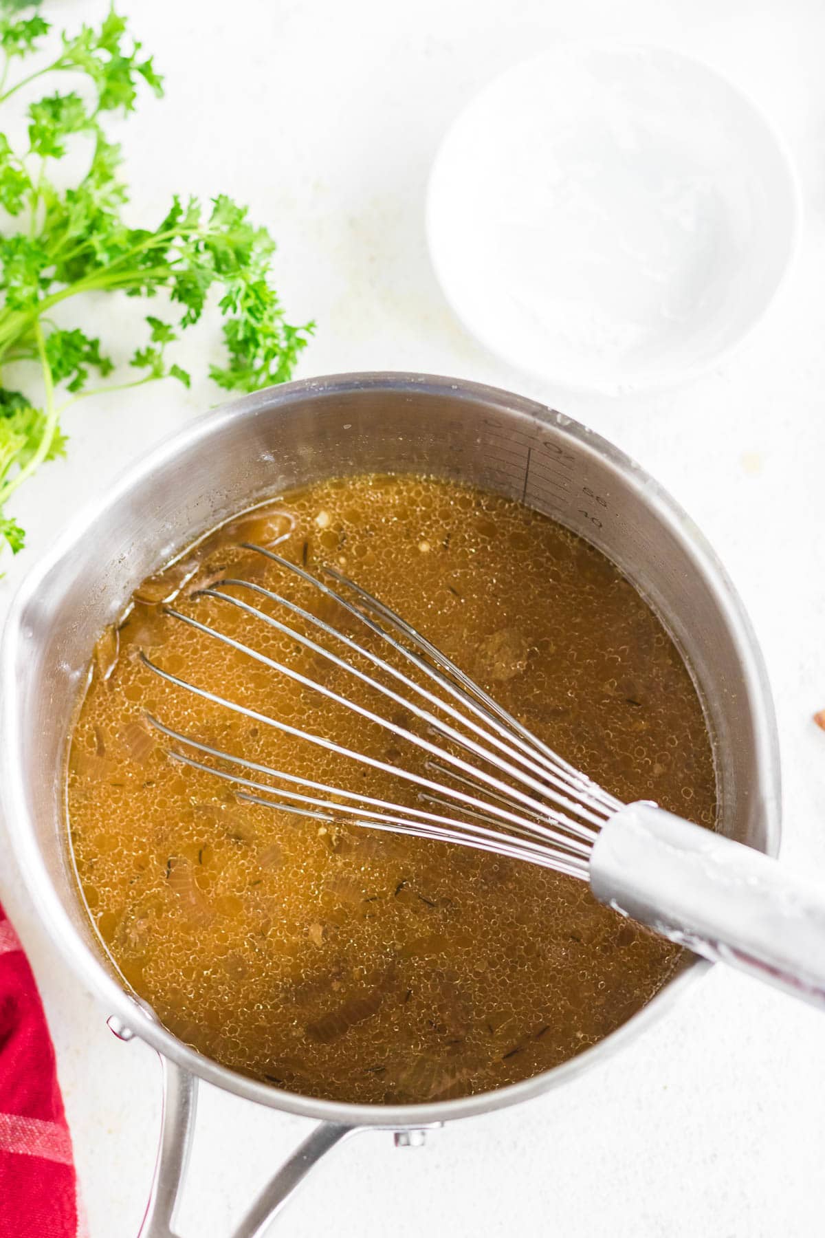 Combining the broth with cornstarch in a saucepan.