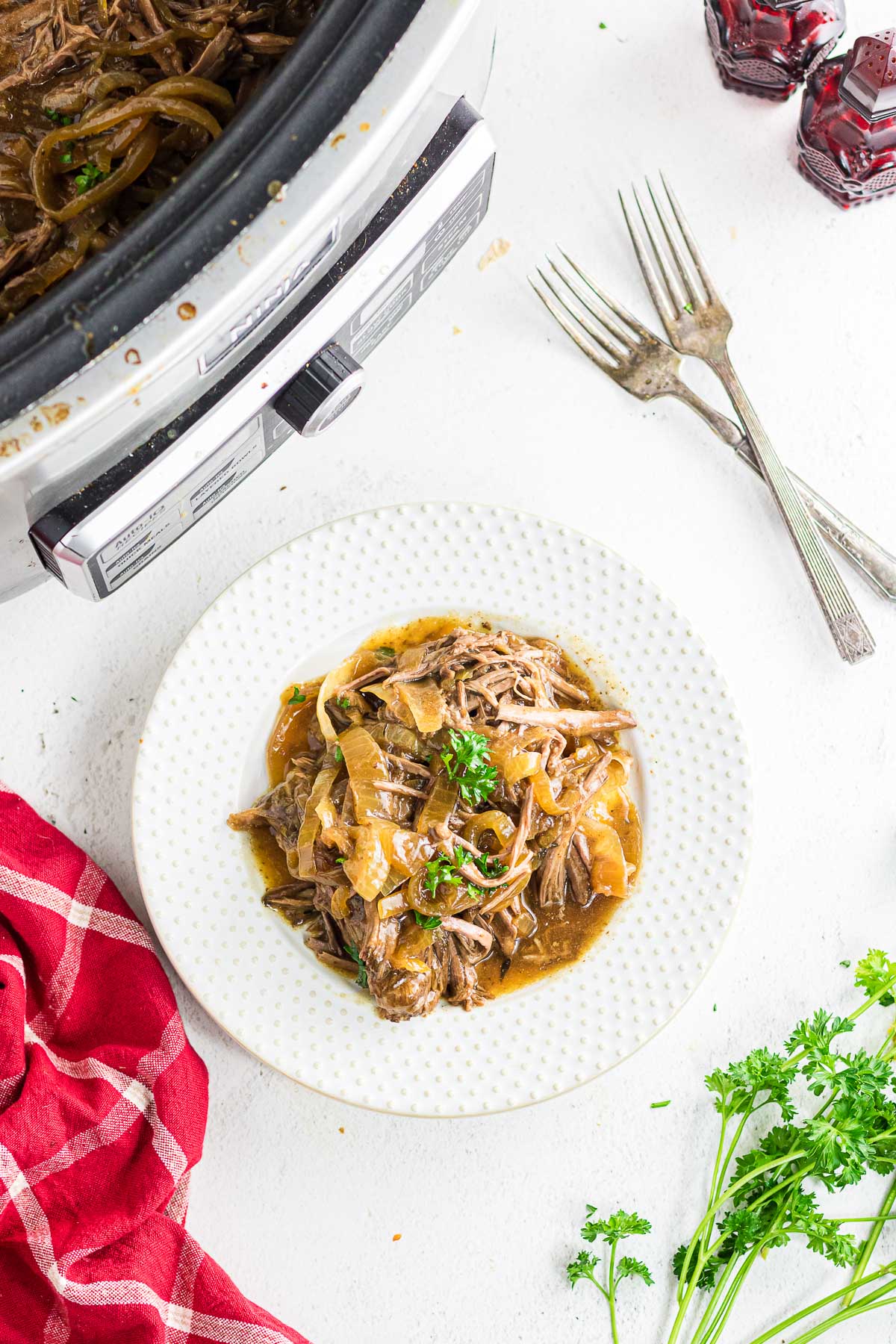 An overhead view of slow cooker French onion pot roast on a serving plate.