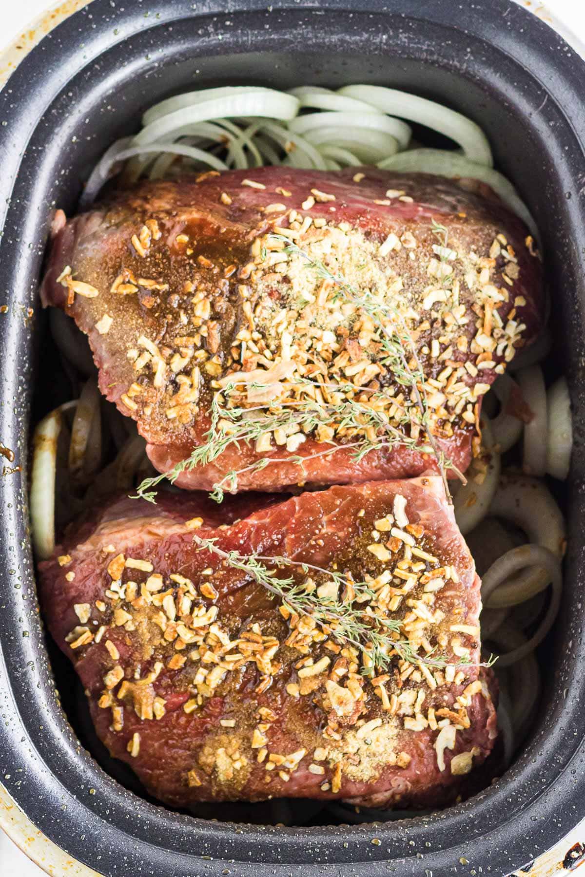 Pot roast rubbed with French onion soup mix and placed over onions.