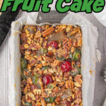 Overhead view of fruitcake with title text overlay for Pinterest.